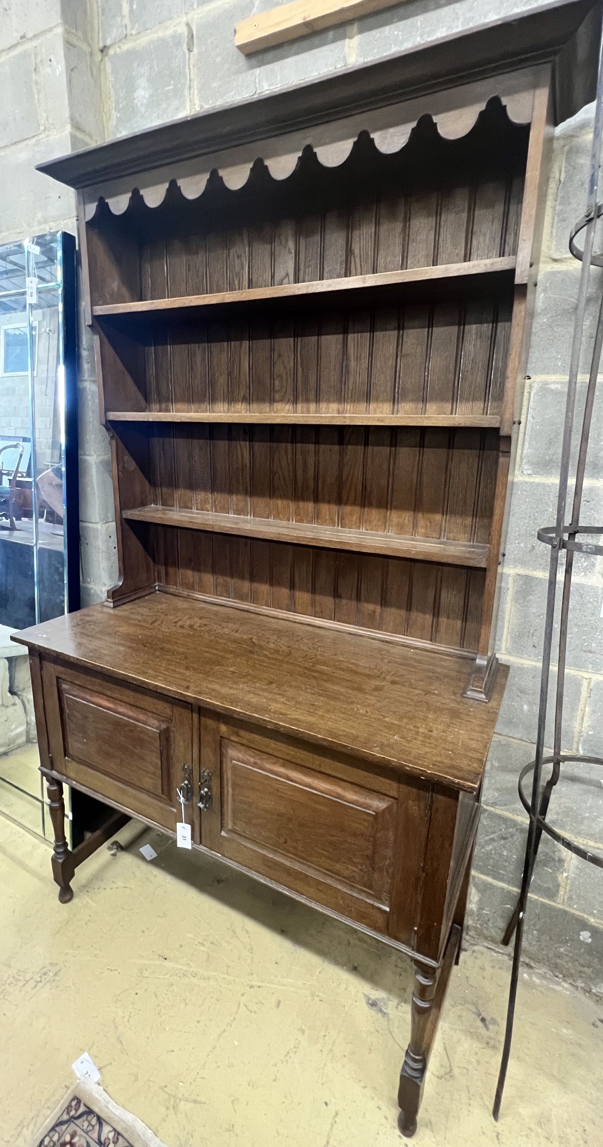 A 1920's oak dresser and plate rack, width 122cm, depth 51cm, height 211cm